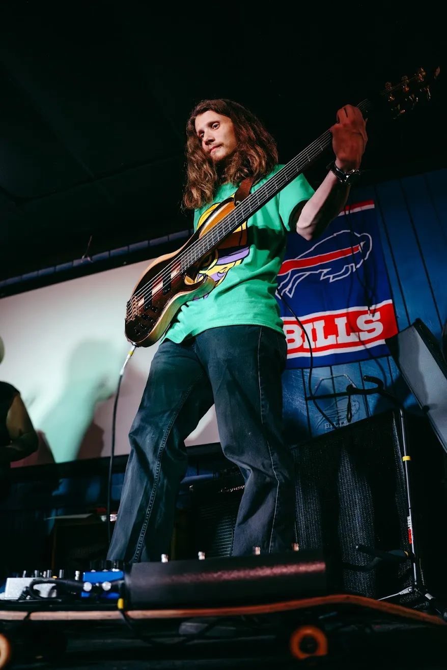 Benji Stiles playing electric bass on stage