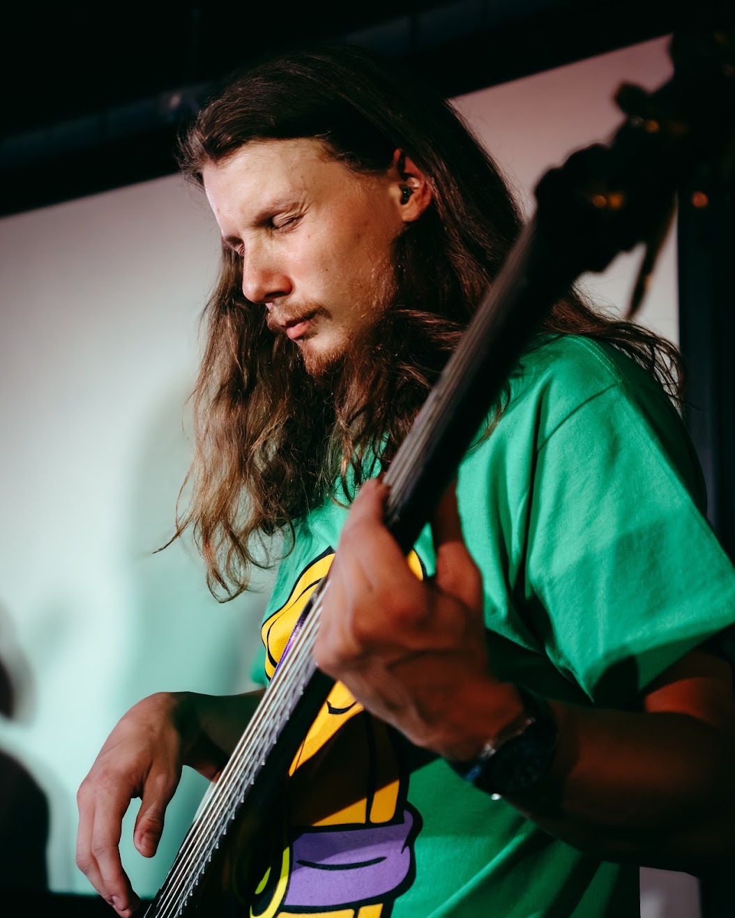 Benji Stiles playing electric bass on stage